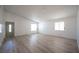 Spacious living room with new flooring, bright windows and light green door at 4409 Rosebank Cir, Las Vegas, NV 89108