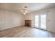 Cozy living room featuring a brick fireplace and glass patio doors to the backyard at 4409 Rosebank Cir, Las Vegas, NV 89108