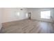 Spacious living room with new flooring, bright windows and light green door at 4409 Rosebank Cir, Las Vegas, NV 89108