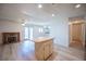 Inviting living room with brick fireplace and light wood flooring, opening to a bright kitchen at 4409 Rosebank Cir, Las Vegas, NV 89108