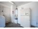 Functional utility room featuring a refrigerator, water heater, and easy access to the exterior at 4409 Rosebank Cir, Las Vegas, NV 89108