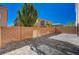 An empty backyard featuring a brick fence and a patterned paved area under a clear blue sky at 4535 Mission Meadow Cir, Las Vegas, NV 89139