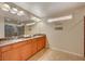 Bathroom with double sinks, granite countertop, large mirror, tile floors, and a glass shower at 4535 Mission Meadow Cir, Las Vegas, NV 89139