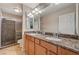 Elegant bathroom with a double sink vanity, stone countertops, and a walk-in shower at 4535 Mission Meadow Cir, Las Vegas, NV 89139