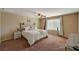 Carpeted bedroom featuring a ceiling fan, window and simple decor at 4535 Mission Meadow Cir, Las Vegas, NV 89139