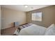 Neutral bedroom showcasing natural light, a cozy bed with a patterned throw, and neutral walls at 4535 Mission Meadow Cir, Las Vegas, NV 89139