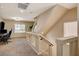 Upstairs hallway with carpet, neutral walls, and glass panel railing at 4535 Mission Meadow Cir, Las Vegas, NV 89139