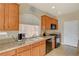 This kitchen features wood cabinets, granite countertops and black appliances at 4535 Mission Meadow Cir, Las Vegas, NV 89139