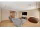 Spacious living room with tile flooring, a entertainment center, and comfortable armchairs at 4535 Mission Meadow Cir, Las Vegas, NV 89139