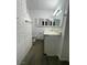 Bathroom featuring white brick accent wall, tiled floors, and vanity at 4560 Rancho Hills Dr, Las Vegas, NV 89119