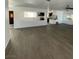 Open-concept living room with laminate flooring and connection to kitchen area at 4560 Rancho Hills Dr, Las Vegas, NV 89119