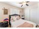 The bedroom has a window and mirror closet with an overhead ceiling fan at 4648 Krissylouise Way, Las Vegas, NV 89121
