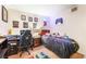 A bedroom featuring gaming decor, a wood frame bed with plush animals, a desk and black chair at 4648 Krissylouise Way, Las Vegas, NV 89121