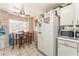 Inviting dining area with tile floors, natural light and an adjacent fridge at 4648 Krissylouise Way, Las Vegas, NV 89121