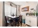 Cozy dining area with a dark wood table set, window, and natural light at 4648 Krissylouise Way, Las Vegas, NV 89121