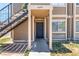 Close up of front door of condominium with walkway and stairwell at 4648 Krissylouise Way, Las Vegas, NV 89121