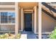 Inviting front entryway featuring a secure, dark-colored security door and warm, neutral-toned siding at 4648 Krissylouise Way, Las Vegas, NV 89121
