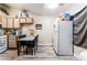 A kitchen area with a dining table, white refrigerator and modern appliances at 4648 Krissylouise Way, Las Vegas, NV 89121