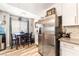 Bright kitchen with stainless steel refrigerator and a dining area with a wood table at 4648 Krissylouise Way, Las Vegas, NV 89121