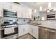 Modern kitchen with stainless steel appliances, gray countertops, and tiled backsplash at 4648 Krissylouise Way, Las Vegas, NV 89121