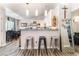 Modern kitchen featuring white cabinetry, a breakfast bar, and stainless steel appliances at 4648 Krissylouise Way, Las Vegas, NV 89121