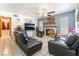 Comfortable living room with a fireplace, tile floors, and black leather sofas at 4648 Krissylouise Way, Las Vegas, NV 89121
