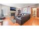 Comfortable living room with wood floors, fireplace, and an entertainment center at 4648 Krissylouise Way, Las Vegas, NV 89121