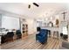 Bright living room featuring a kitchen bar, blue armchair, and plenty of natural light at 4648 Krissylouise Way, Las Vegas, NV 89121