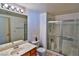 Bathroom featuring a shower with glass doors, white toilet, and wood vanity at 4655 Gold Dust Ave # 206, Las Vegas, NV 89120