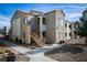 A stucco two-story condo building with stairs up to the second floor and desert landscaping at 4655 Gold Dust Ave # 206, Las Vegas, NV 89120