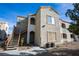 A stucco two-story condo building with stairs up to the second floor and desert landscaping at 4655 Gold Dust Ave # 206, Las Vegas, NV 89120