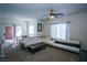 Bright living room featuring a ceiling fan, carpet, and modern furniture with large windows at 4655 Gold Dust Ave # 206, Las Vegas, NV 89120