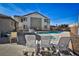 Community pool offers refreshing retreat, surrounded by lounge chairs and manicured landscaping under sunny sky at 4655 Gold Dust Ave # 206, Las Vegas, NV 89120