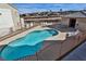 Community pool offers refreshing retreat, surrounded by lounge chairs and manicured landscaping under sunny sky at 4655 Gold Dust Ave # 206, Las Vegas, NV 89120