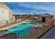 Community pool offers refreshing retreat, surrounded by lounge chairs and manicured landscaping under sunny sky at 4655 Gold Dust Ave # 206, Las Vegas, NV 89120