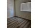 A bright bedroom with new wood flooring and two large windows at 4730 E Craig Rd # 1148, Las Vegas, NV 89115