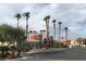Stylish clubhouse exterior with terracotta roofs and lush palm trees, showcasing the community's amenities and architecture at 4730 E Craig Rd # 1148, Las Vegas, NV 89115