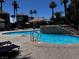 Relaxing community pool with lounge chairs and a decorative stone feature, perfect for enjoying sunny days at 4730 E Craig Rd # 1148, Las Vegas, NV 89115