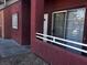 Exterior view of a unit with a white front door, a red frame, and a sliding glass door at 4730 E Craig Rd # 1148, Las Vegas, NV 89115