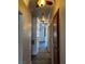 A well-lit hallway with wood flooring, ceiling fans, and storage at 4730 E Craig Rd # 1148, Las Vegas, NV 89115