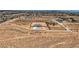 A distant aerial view showcases a desert home with a long driveway, blending modern living and natural surroundings at 4740 W Agate Ave, Las Vegas, NV 89139