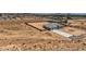 An aerial shot displays a modern desert home with an expansive lot, long driveway and perimeter brick wall at 4740 W Agate Ave, Las Vegas, NV 89139