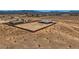 Expansive desert property featuring two houses and a large dirt yard enclosed by a brick wall at 4740 W Agate Ave, Las Vegas, NV 89139