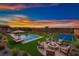 Large backyard features a pool, paddle tennis court, fire pit, and outdoor furniture at 4740 W Agate Ave, Las Vegas, NV 89139