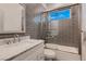 Bathroom features tiled shower and tub combo with glass doors and a marble countertop sink at 4740 W Agate Ave, Las Vegas, NV 89139