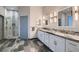 Bright bathroom features a double sink vanity with granite counters and a glass enclosed shower at 4740 W Agate Ave, Las Vegas, NV 89139