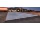 Wide concrete driveway leads to a modern single-story house with a three-car garage, blending style and function at 4740 W Agate Ave, Las Vegas, NV 89139