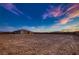 Large vacant lot ready for construction with an existing house in the background at 4740 W Agate Ave, Las Vegas, NV 89139