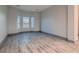 Sunlit room with light-colored flooring, neutral walls, and large windows offers a versatile space for any decor at 4740 W Agate Ave, Las Vegas, NV 89139
