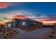 A modern single-story house features desert landscaping and a brick-paved driveway leading to an automated gate at 4740 W Agate Ave, Las Vegas, NV 89139